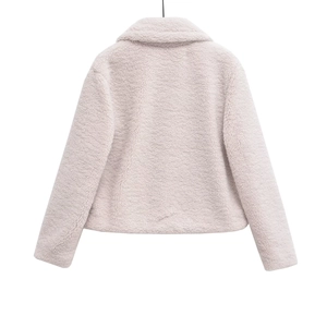 Detailed macro view of the soft faux shearling fleece texture on this cropped jacket