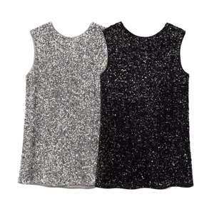 Close-up of sparkling silver and black sequin sleeveless party tops in a flat lay view
