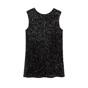 Detailed macro view of black sequins on a sleeveless mini party dress with light reflection