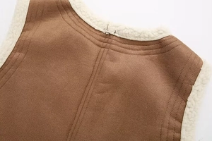Macro detail of brown suede fabric and white lamb wool lining with precise triple stitching