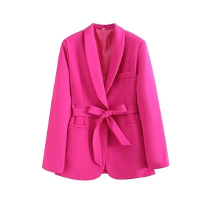 Detail of magenta blazer featuring a matching waist belt and classic shawl lapel design