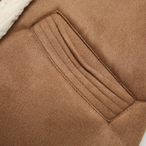 Detail of brown faux suede vest showing lamb wool lining and refined pocket stitching