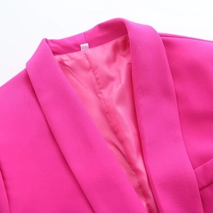 Detail of rose pink blazer showing notched lapel and smooth satin lining texture