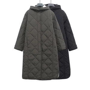 Detail view of quilted diamond patterns and hood on longline military green coat