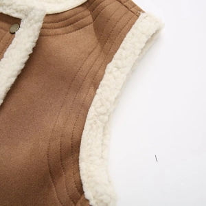 Detail of brown faux suede vest showing sherpa fleece lining and metal button