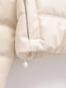 Detailed view of the adjustable drawstring hem on this beige PU leather padded jacket