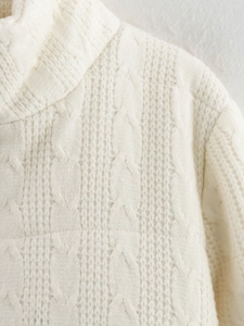 Detail of white cable knit stand collar and soft textured fabric on winter cardigan