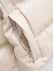 Detailed close-up of quilted PU leather jacket with hidden zipper pocket in beige