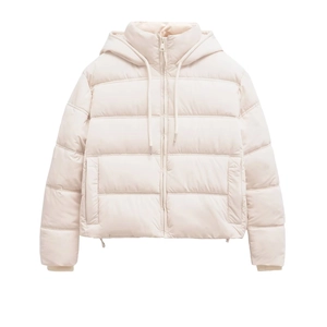 Detailed close-up of quilted beige hooded puffer jacket with drawstring and zipper