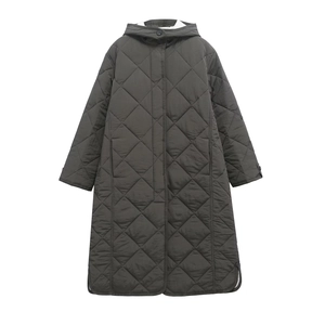 Macro shot of diamond quilted texture and hood detail on women long oversized coat
