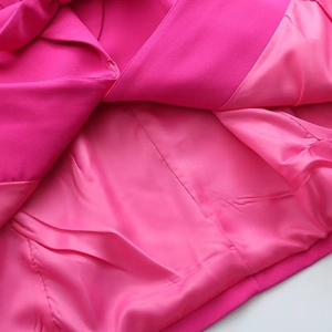 Detailed macro view of magenta blazer interior with premium twill fabric and satin lining