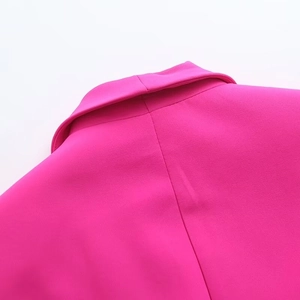 Detail of hot pink blazer collar featuring fine texture and clean back stitching