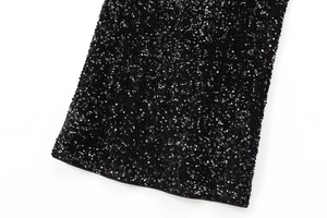 Close-up of high-density black sequins with metallic shine and tight stitching detail