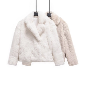 Close-up of white and beige faux fur jackets showing soft texture and lapel design