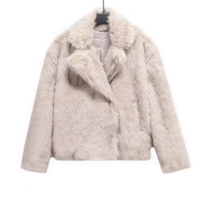 Detail of light beige faux fur coat featuring a large lapel and silky smooth lining