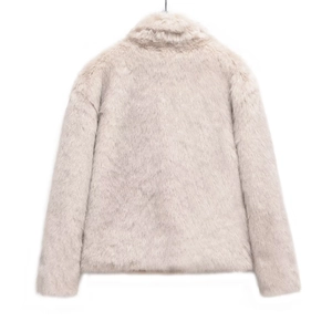 Detailed texture of fluffy beige faux fur on a short winter jacket with a soft finish