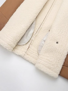 Women's autumn faux shearling vest with brown suede exterior and white wool lining detail