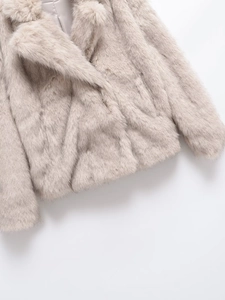 Detailed macro view of soft faux fur texture and silky inner lining of the beige coat