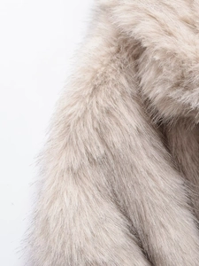 Macro close-up showing soft texture and long fibers of faux fur lapel in beige brown color