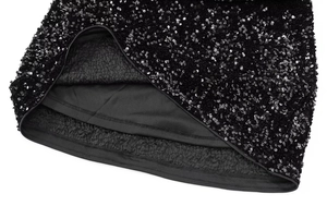 Detail shot of high-density black sequins with warm fleece lining on a party mini dress
