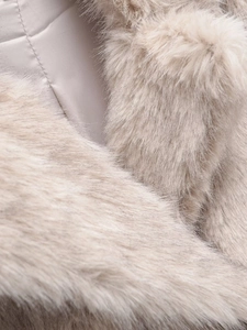 Macro detail of soft beige faux fur texture with smooth inner lining on winter coat