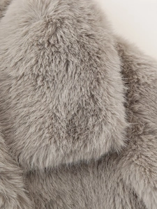 Close-up macro view of the soft grey faux fur texture on this stylish autumn jacket