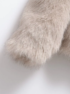 Close-up of fluffy faux fur texture in light camel beige with soft long hair fibers