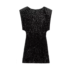 Detail of a sparkling black sequined mini dress with padded shoulders for party wear