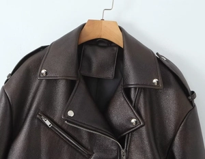 Détails de la veste de moto en similicuir marron foncé avec boutons et fermetures