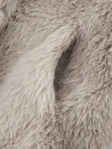 Detail shot of light brown faux fur texture and seam craftsmanship on this coat