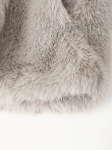 Close-up of thick light gray faux fur texture showing soft dense fibers on the lapel