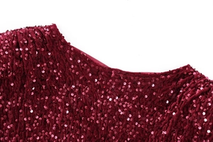 Detail of burgundy sequin party dress showing high density round sequins and stitching