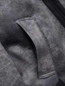 Macro detail of high-quality charcoal gray twill fabric and welt pocket on jacket