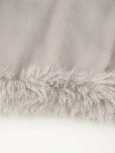 Detail of soft faux fur trim and textured plain fabric on a stylish winter jacket