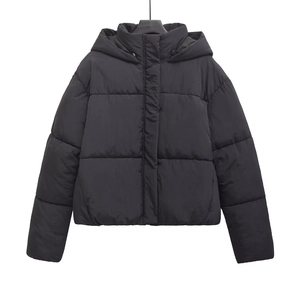 Detail view of the high-collar hood and thick quilted texture of the black puffer jacket