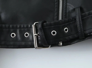 Detailed close-up of a black PU leather biker jacket featuring silver metal belt buckles
