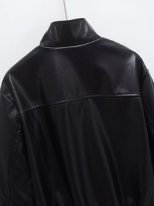 Detailed back view of black faux leather jacket showing stitching and refined texture