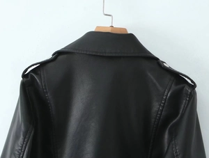 Detail of black PU leather biker jacket featuring lapel collar and shoulder epaulettes