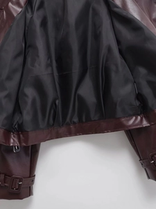 Détail de la veste en PU bordeaux avec ceinture réglable et doublure noire de qualité