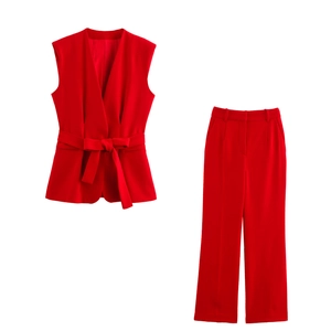 Detail view of red V-neck sleeveless belted vest and wide-leg trousers suit set