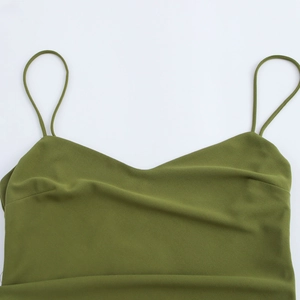 Close-up of grass green backless maxi dress showing textured fabric and fine straps