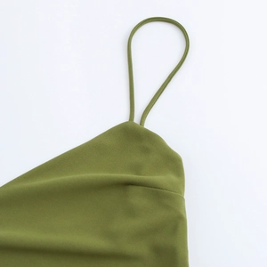 Detailed view of the thin olive green strap and clean stitching on this backless maxi dress