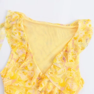 Detailed view of yellow floral mesh dress featuring layered ruffles and V-neckline