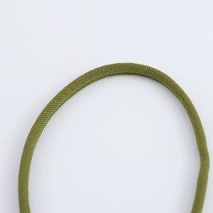 Macro texture of the olive green knitted elastic fabric showing high-quality stitching