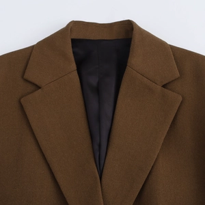 Close-up of classic lapel and twill texture on a brown casual blazer with black lining