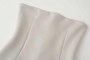Detailed close-up showing precise darts and stitching on the light gray bandeau top fabric