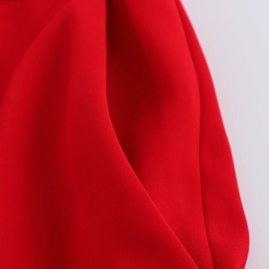 Close-up of premium red knit fabric showing detailed stitching and textured pocket craftsmanship
