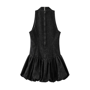 Detail of black washed denim dress showing back metal zipper and pleated puff hem