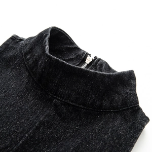 Detail of vintage washed black denim standing collar with a silver metal zipper closure