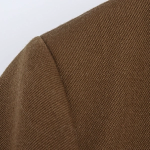 Close-up of premium brown twill fabric texture and shoulder stitching detail